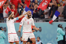 Nov 30, 2022; Al Rayyan, Qatar; Tunisia defender Ali Maaloul (12) and forward Issam Jebali (9) celebrate after defeating France in a group stage match during the 2022 World Cup at Education City Stadium. Mandatory Credit: Yukihito Taguchi-Imagn Images