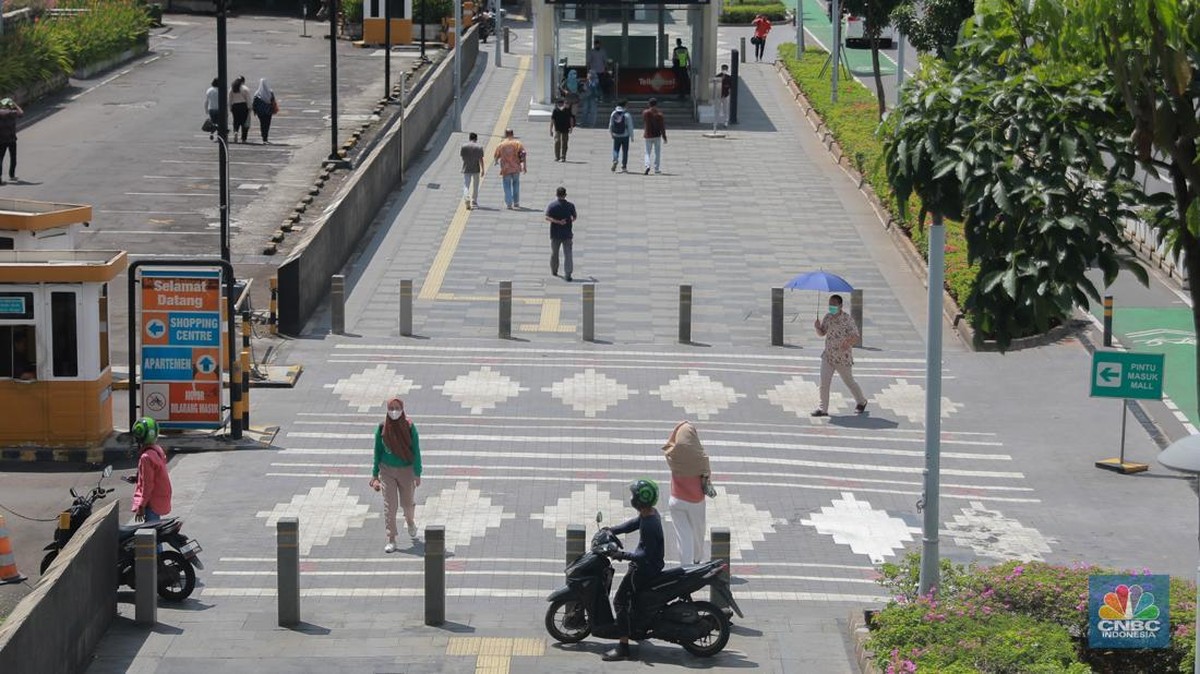 Foto: Sejumlah pekerja berjalan pulang di Kawasan Sudirman, Jakarta, Jumat (13/12/2024). (CNBC Indonesia/Muhammad Sabki)